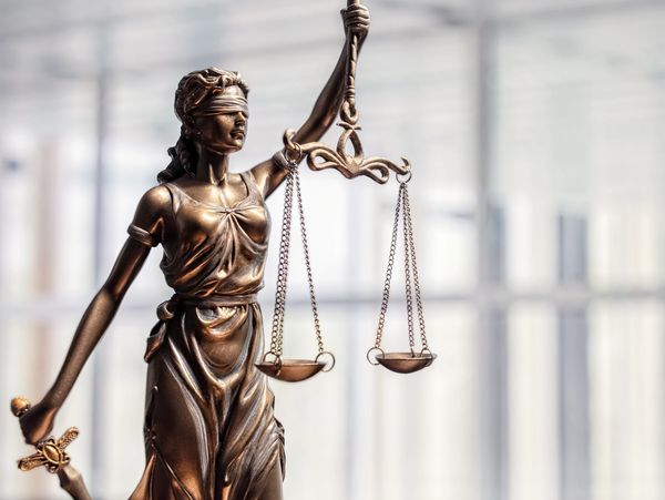 Lady Justice scales representing fairness and professional consulting